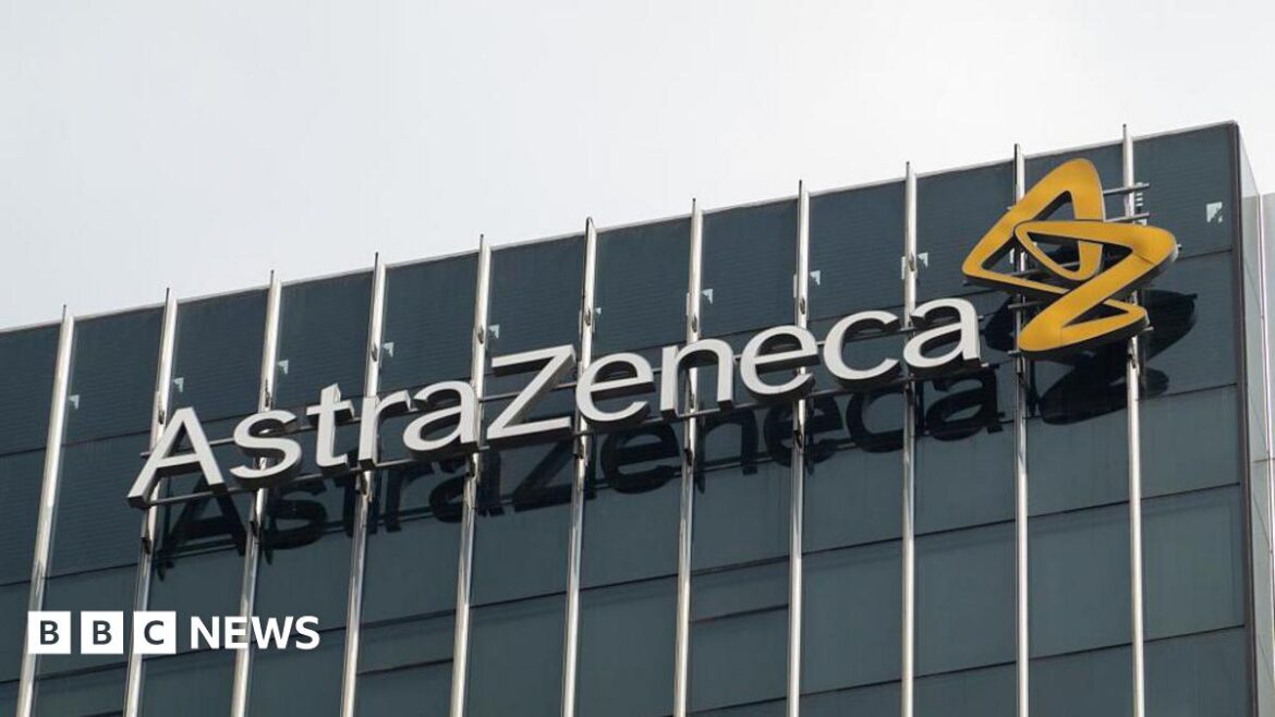 Pharmaceutical company Astrazeneca's logo on the side of an office building with dark opaque windows. There is a grey sky behind the building.