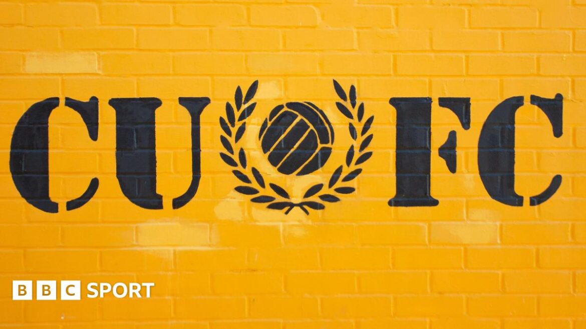 Yellow wall decorated with Cambridge United FC initials