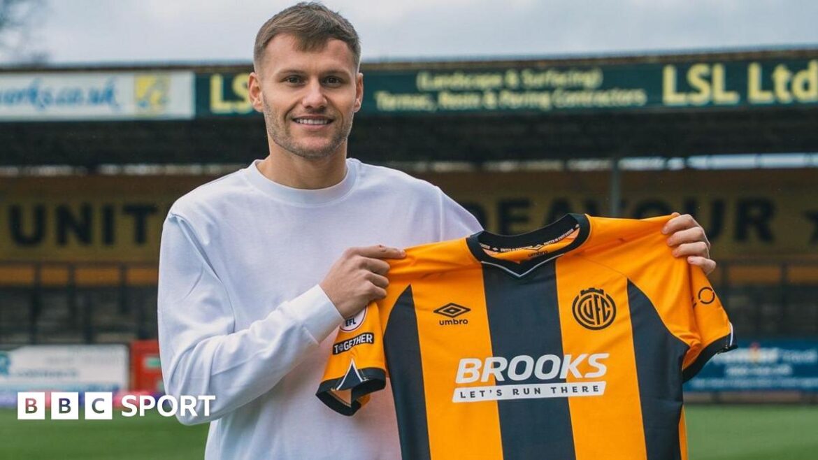 Elliott Nevitt pictured holding a Cambridge shirt