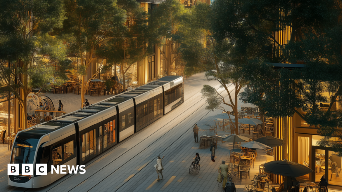 An artist's impression of the forest city. A modern tram runs through a street between high rise buildings which have orange lights coming out of them. People can be seen walking along the street. Tables and chairs sit outside some of the buildings and there are a lot of trees and greenery.