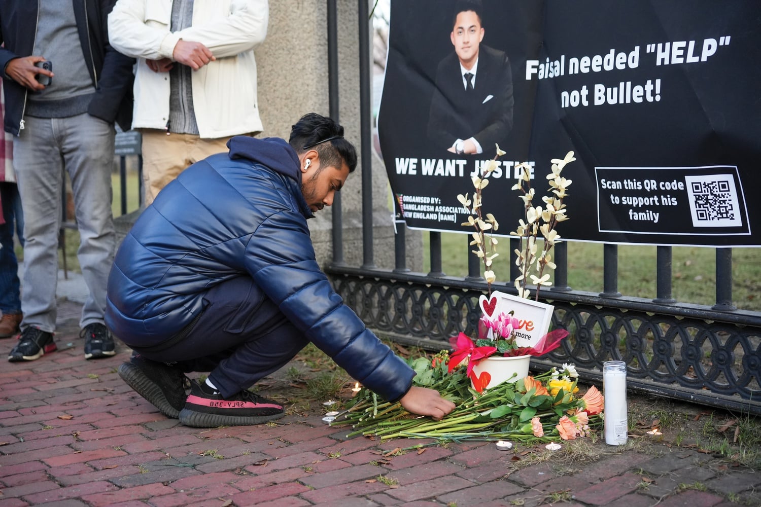Residents gather for candlelight vigil honoring Sayed Faisal near site where killed.